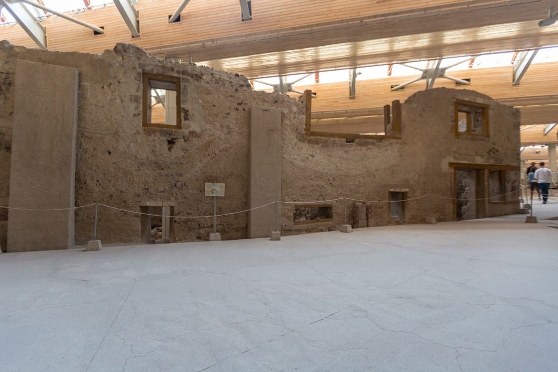 Visitors walking inside the covered Akrotiri excavation site