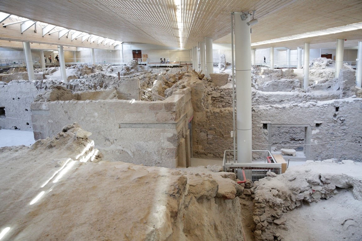 Visitors exploring the Akrotiri archaeological site